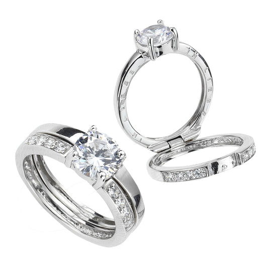 Ring Silber 925 rhodiniert mit 9 weißen Zirkonia-Steinen. Der Ring ist aufklappbar uind mit einer Inschrift "In Liebe" versehen.